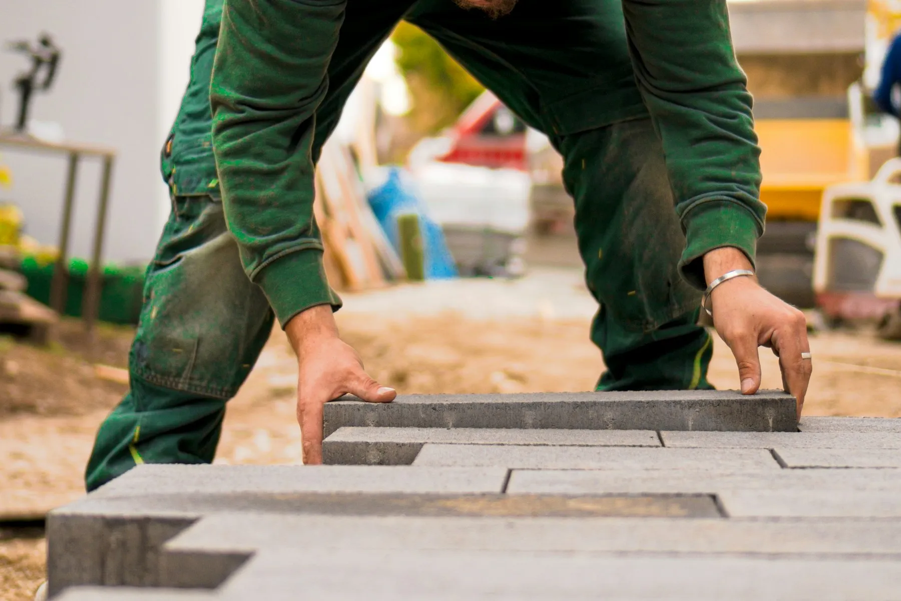 Paving slabs being laid by hand onto a prepared base