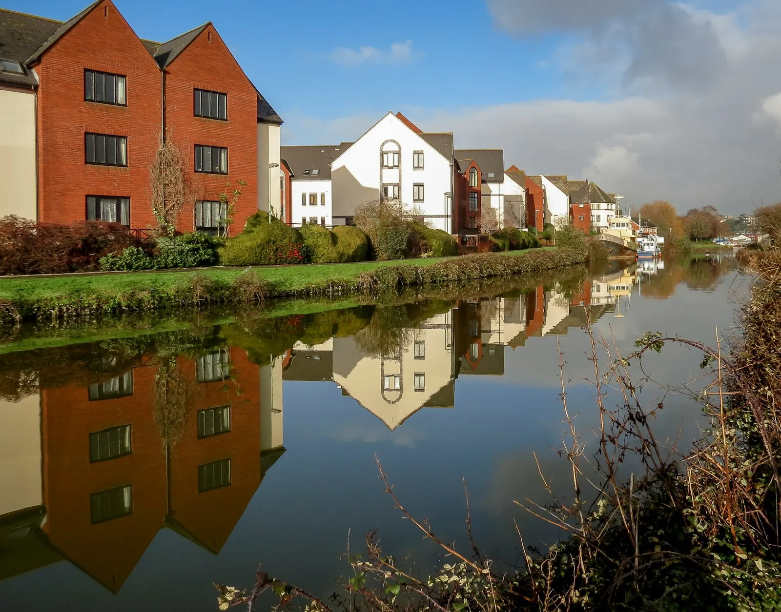 Riverside properties reflected in the water at Exeter Quay